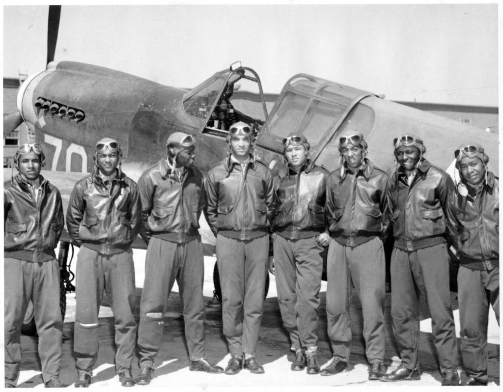 Tuskegee Airmen from class 42I posing in front of an airplane